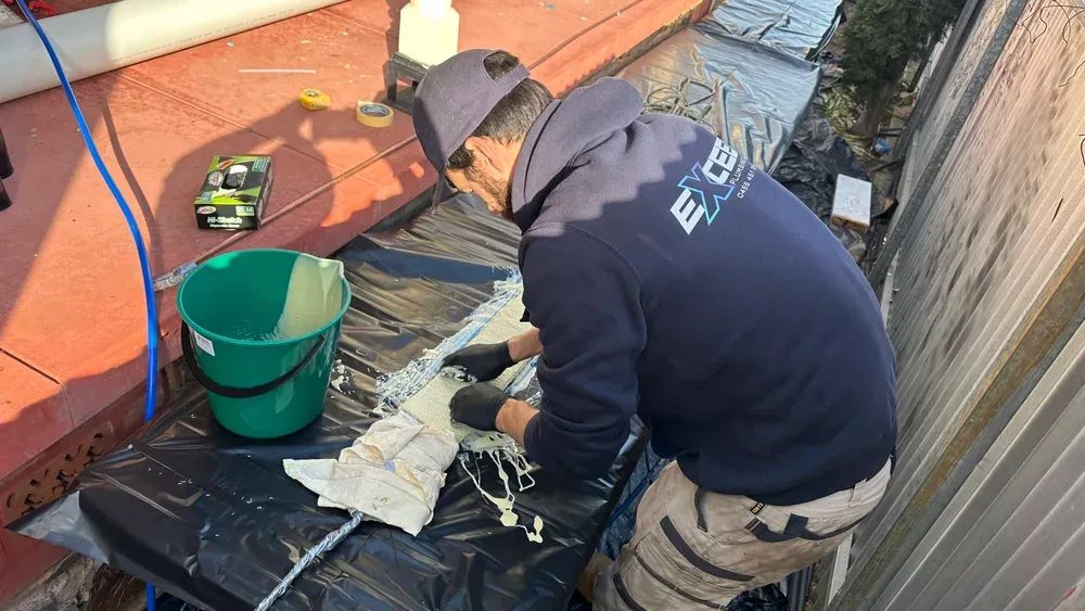 Plumber preparing a pipe relining liner on site